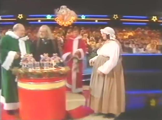 Leighton Rees dressed as a green Father Christmas, Jim Bowen dressed as scrooge, Bella Emberg dressed as a Dickensian maid