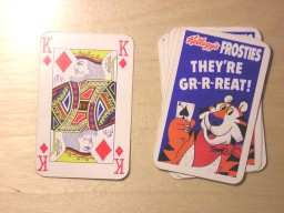 The same picture as before, but the top card has been turned over and placed next to the pile of cards. It is the king of diamonds