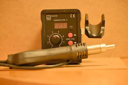 [a hot air solder rework station that looks like a black box with a very wide pen thing attached]
