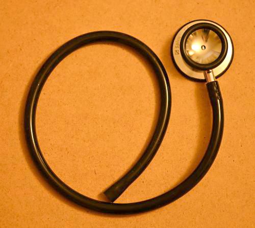 [the round end of a stethoscope with a length of tubing attached. It has been cut off from the part that goes in the ears]